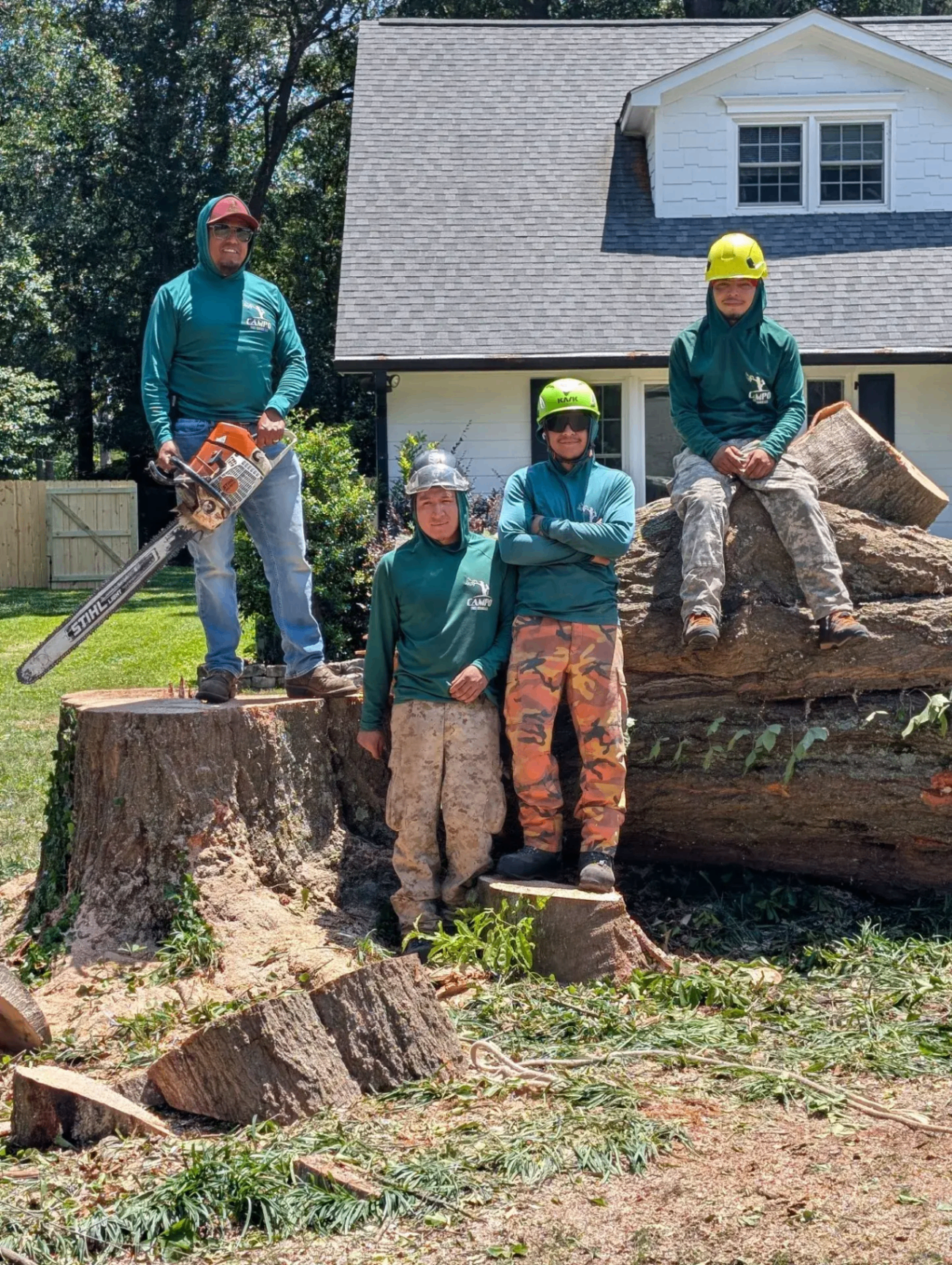 The Campo Tree Service crew standing in front of their work truck and wood chipper